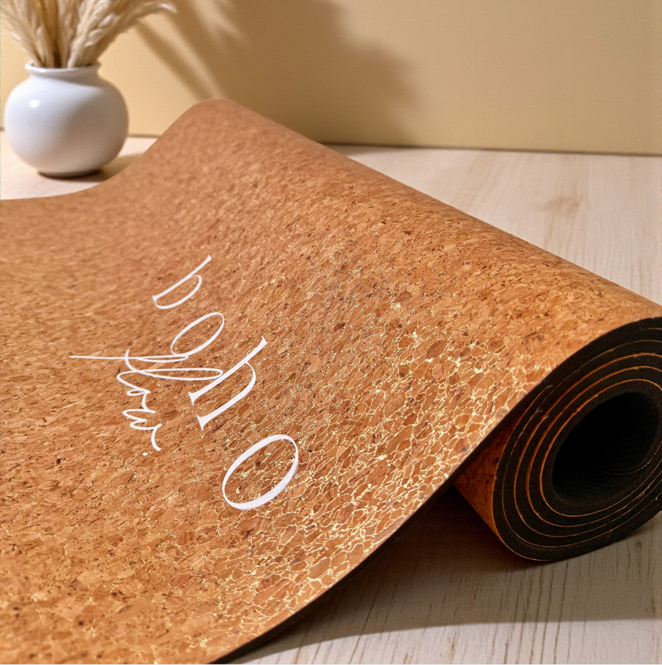 The Boho Flow gold cork yoga mat with 'Aurum Aura' branding in a close-up shot on a wooden surface.