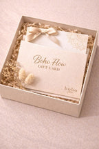 Boho Flow gift card in a decorative box with dried flowers on a light pink background