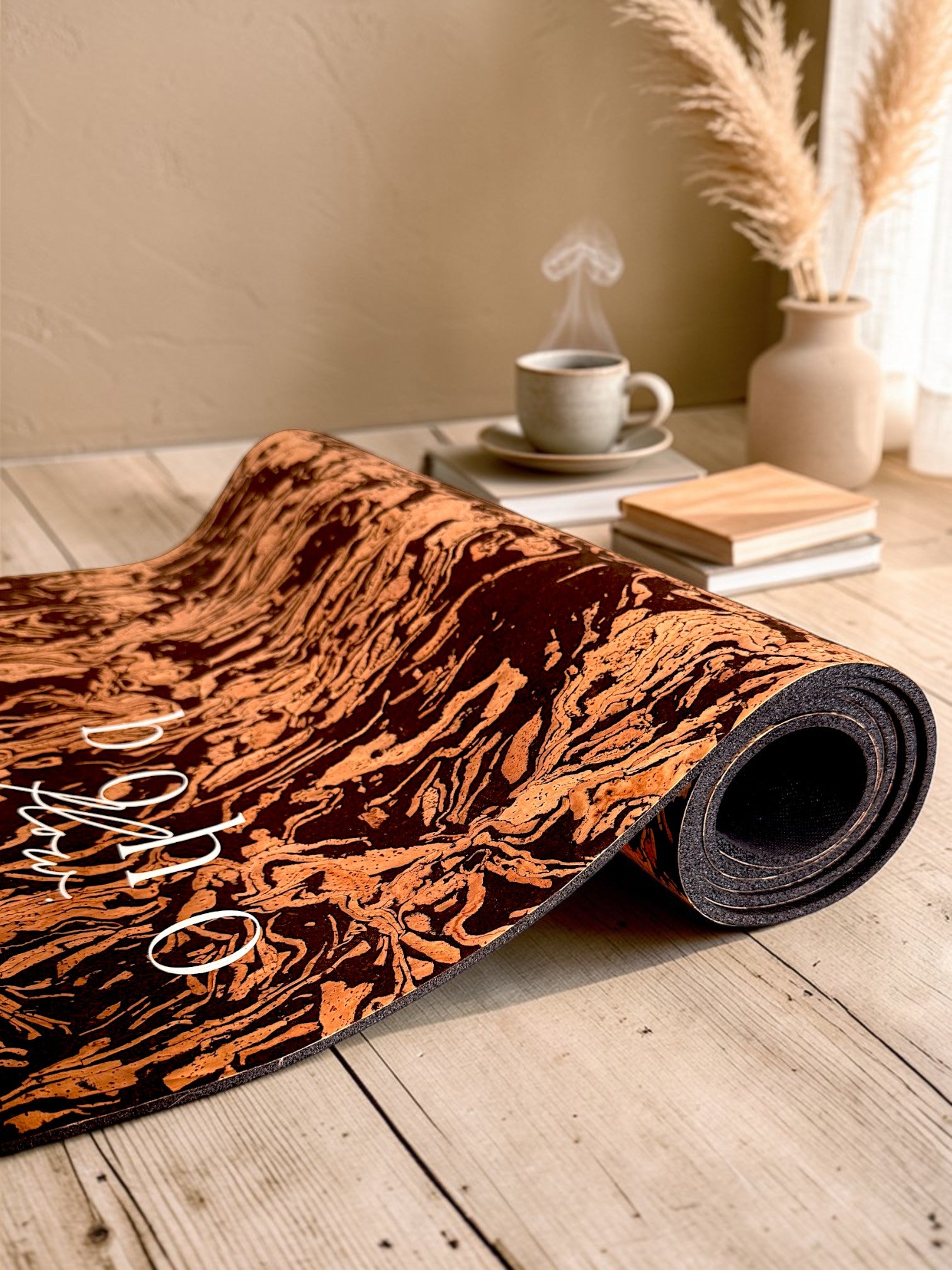 A close up angled shot of the Boho Flow coffee cork mat, Caffè Core, on a rustic table with its texture visible and a coffee mug in the back.