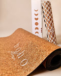 Boho Flow Gold Cork yoga mat product shot up close with gold texture visible and complementary boho bag and box in the background.