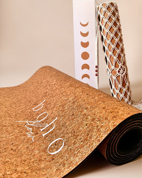 Boho Flow Gold Cork yoga mat product shot up close with gold texture visible and complementary boho bag and box in the background.