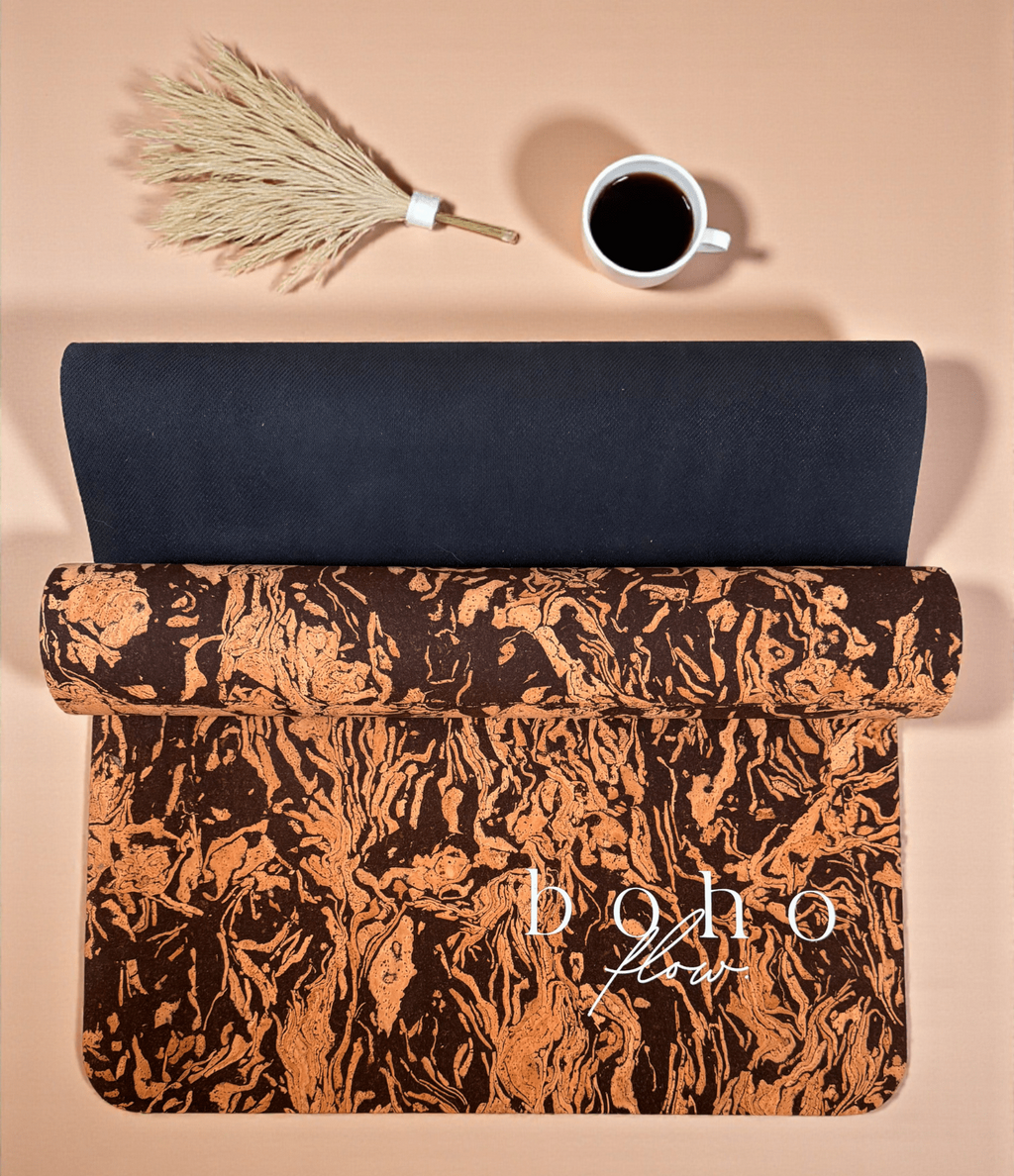 Rolled Up Boho coffee and cork yoga mat with  'boho flow' text on a beige background with a cup of coffee and dried plant.