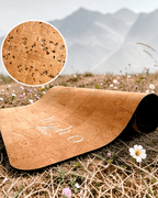 Boho Flow Luxe Vegan Leather Cork yoga mat with texture detail and 'Boho Flow' branding on grass with mountains in the background.