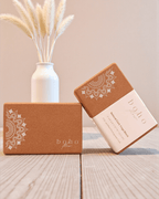 Two cork yoga blocks with white mandala patterns and 'boho flow' branding on a wooden surface.