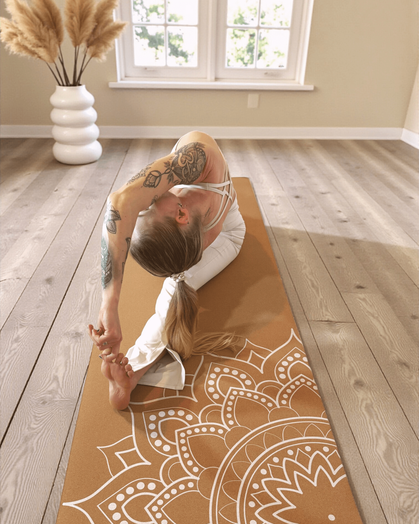 Person practicing yoga on a cork yoga mat with a mandala print in a home setting