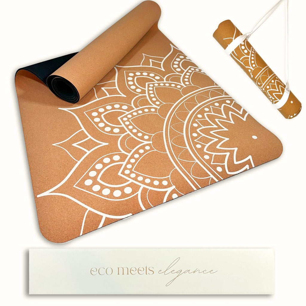 Cork Yoga mat with white mandala design on a white background with second rolled up mat in a carry strap.
